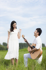 Young couple enjoying music outdoors