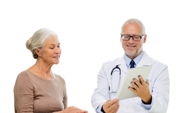 smiling senior woman and doctor with tablet pc