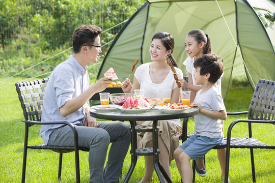 Young family picnicking outdoors