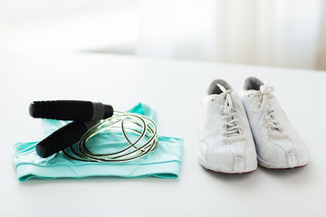 close up of sports top, sneakers and skipping rope - obrazy, fototapety, plakaty