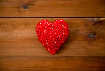 close up of red heart decoration on wood