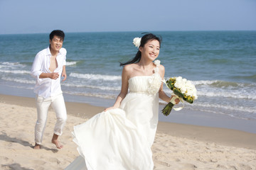 Fototapeta na wymiar Happy newlyweds on the beach