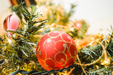 Close up of New Year baubles on decorated Christmas Tree with blurred and sparkling background
