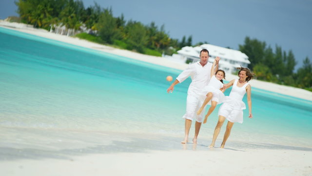 Caucasian family parents girl white clothes beach ocean island vacation tourism