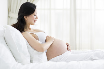 Pregnant woman resting in bed