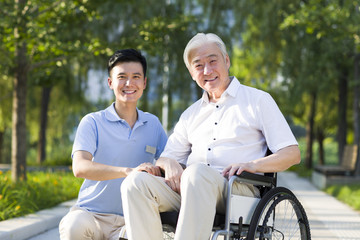 Wheelchair bound man with nursing assistant
