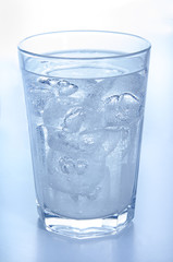 glass with ice cold, bubbling mineral water