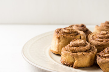 Cinnamon rolls on the wooden background
