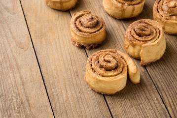Cinnamon rolls on the wooden background