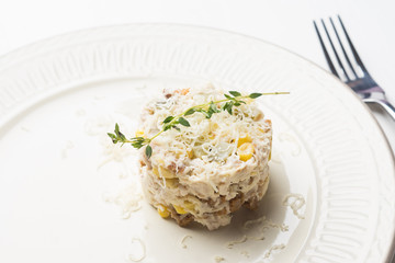 Chicken salad with cheese served on the beige plate