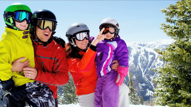 portrait Caucasian family parents children lifestyle snow mountains destination