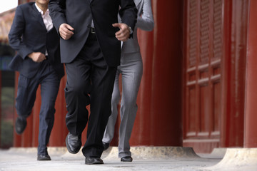 Three Business People Running Through The Forbidden City In Beijing