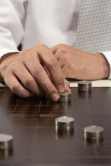 Office worker playing Chinese chess with investment capital