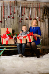 the boy and his mother with Christmas gift in hands.