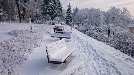 Benches in mountains covered with fresh snow