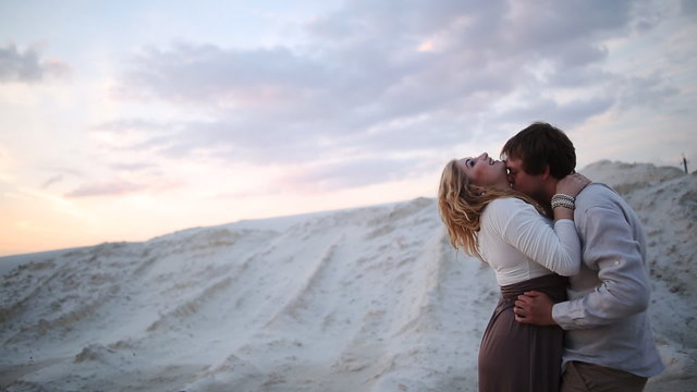 man and woman kiss background sand 
