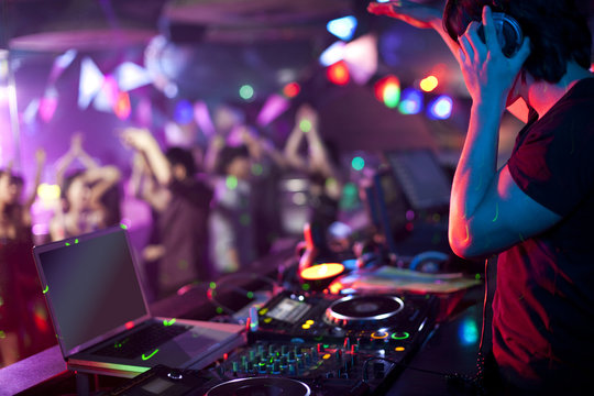 DJ doing record Scratching in nightclub