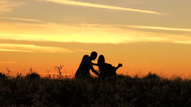 Carefree Caucasian Family Enjoying Vacation Together Outdoors Sunset Silhouette