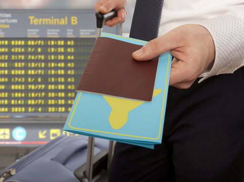 Businessman handing passport and ticket