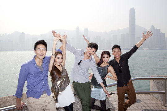 Cheerful Young Friends Appreciating The Spectacular View Of Victoria Harbor, Hong Kong