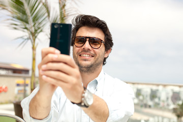 Man taking a photo with a mobile phone