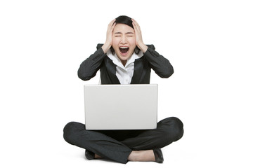 A businesswoman holding a laptop computer