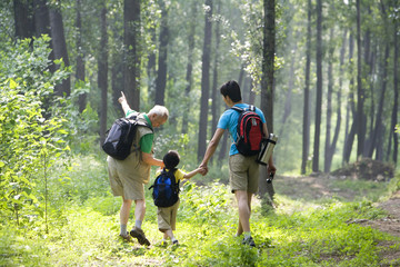 Boy hiking with his father and grandfather