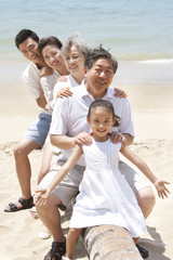 Happy family posing at the beach