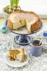 Coconut and lime cheesecake with passion fruit and caramel. Christmas decoration, hyacinth and blue plateau.