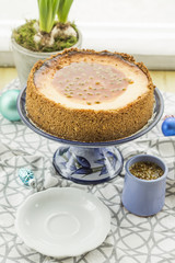 Coconut and lime cheesecake with passion fruit and caramel. Christmas decoration, hyacinth and blue plateau.