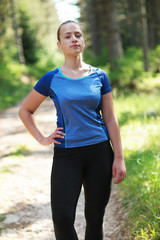 Attractive fit woman in sportswear training outdoors, female ath