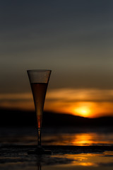 Champagne flute glass against sunset