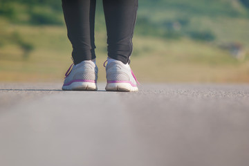 Female athlete runner. closeup on shoe. woman fitness sunset jog