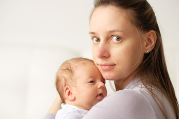 One month old newborn baby with mother