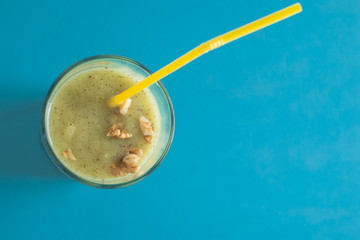 Chocolate banana smoothie in a glass with straws