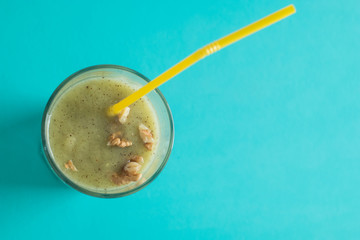 Chocolate banana smoothie in a glass with straws