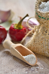 Salt spoon on wooden background