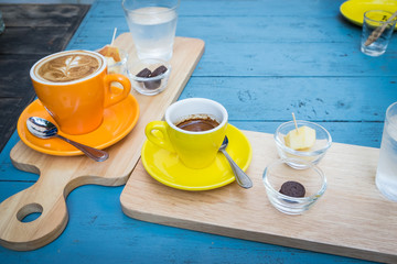 hot espresso shot in yellow cup on wooden table
