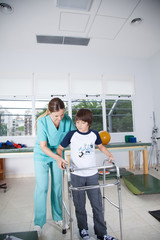 Therapist woman with boy in rehab