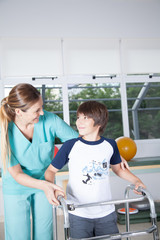 Therapist woman with boy in rehab