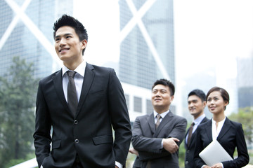 Cheerful businessman with his team in Hong Kong
