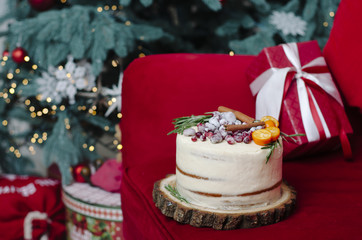 Christmas cake near the Christmas tree and gifts