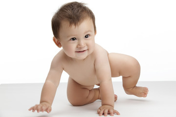 Studio shot of a cute baby boy crawling