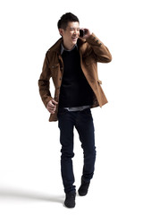 Naklejka premium Stylish young man with moblie phone