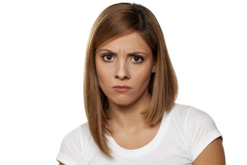 angry young woman on a white background