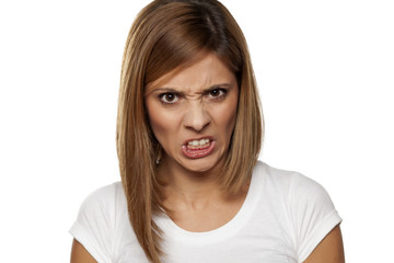 angry young woman on a white background