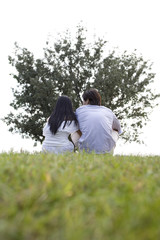 Young couple sitting in park