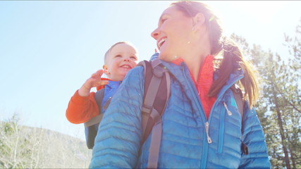 outdoor lifestyle Caucasian mother baby parent nature backpack spring hiking fit