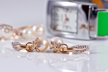 gold jewelry with pearls and elegant women's watches
