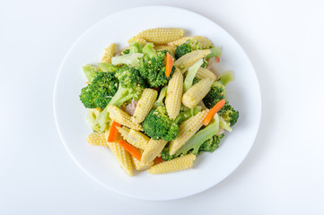 Green broccoli,baby corn,carrot on the plate